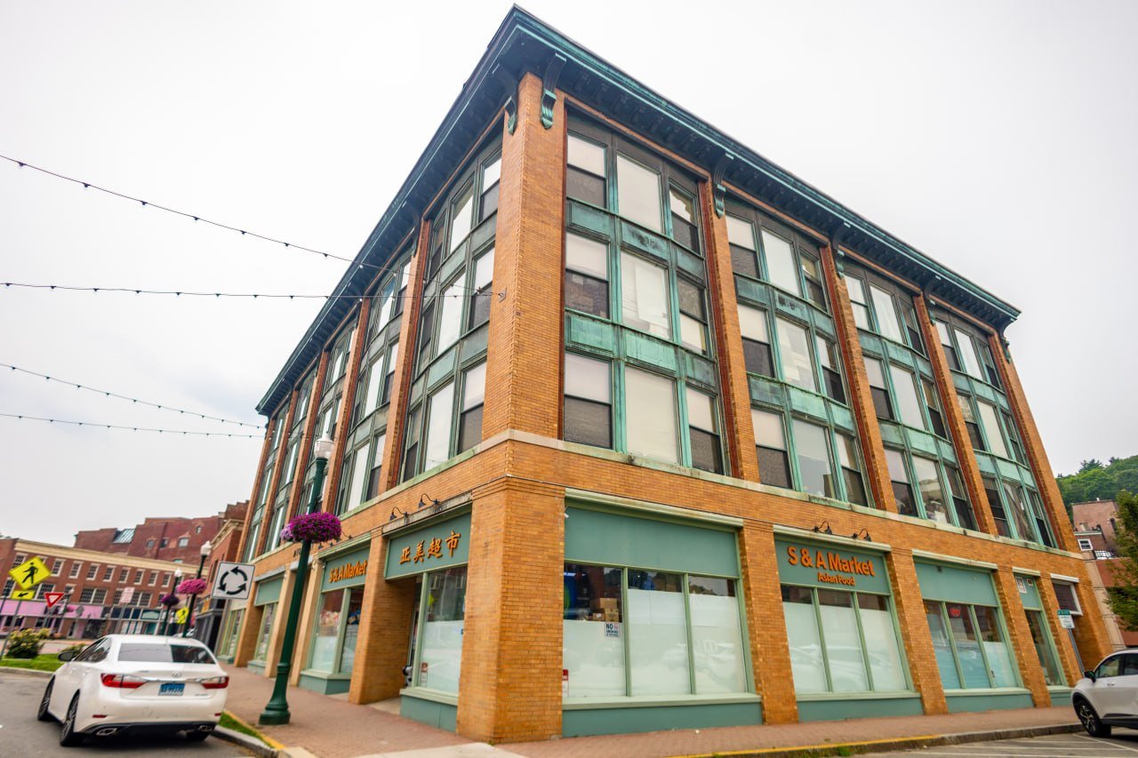 Corner street view of the historic Thayer building with S&A Market