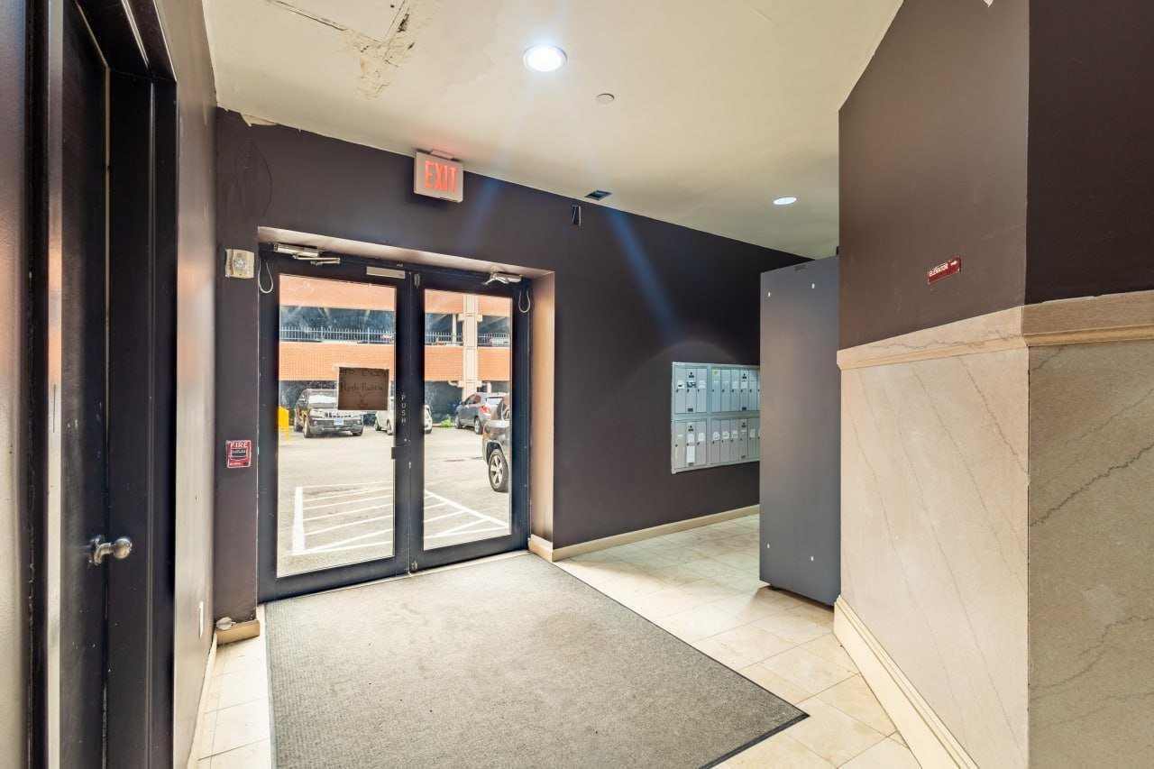 Entrance vestibule with tenant mailboxes and elevator access