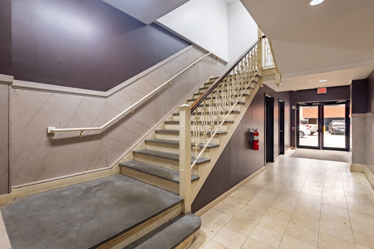 Historic lobby staircase with wrought-iron balustrade