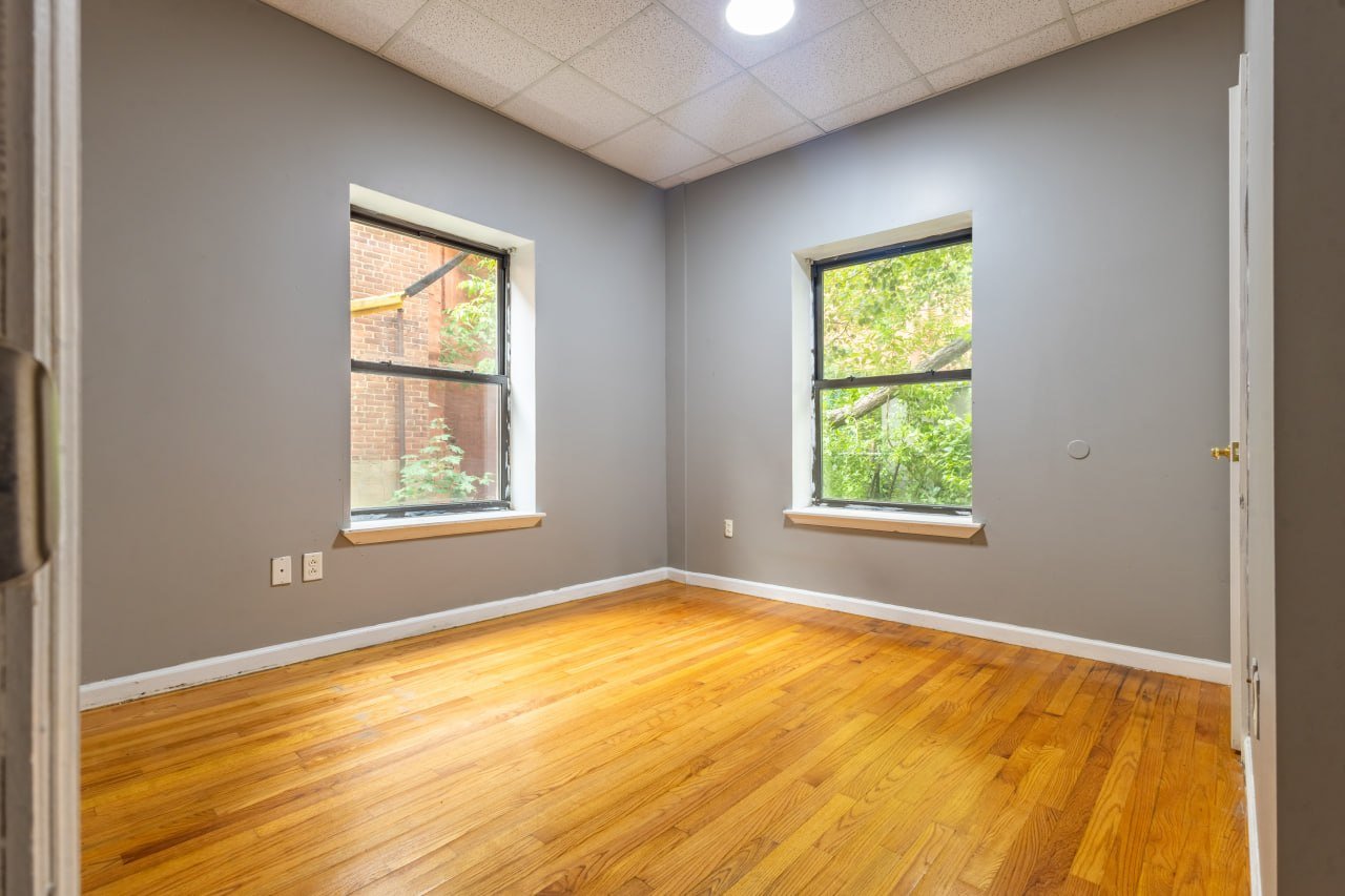 Unit 102 corner bedroom with two windows